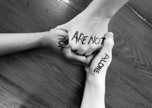 A picture showing hands held together for suicide prevention